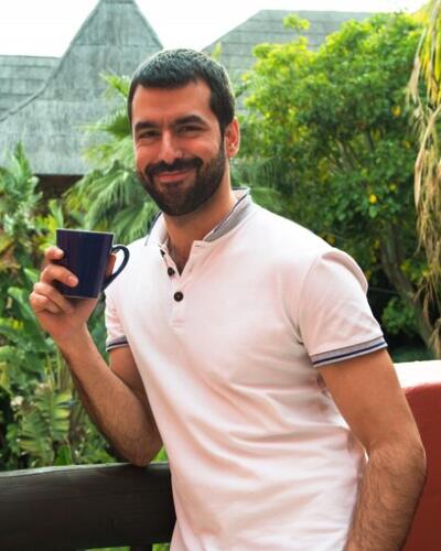 A relaxed man enjoying coffee, representing easy-going Delhi gay chat